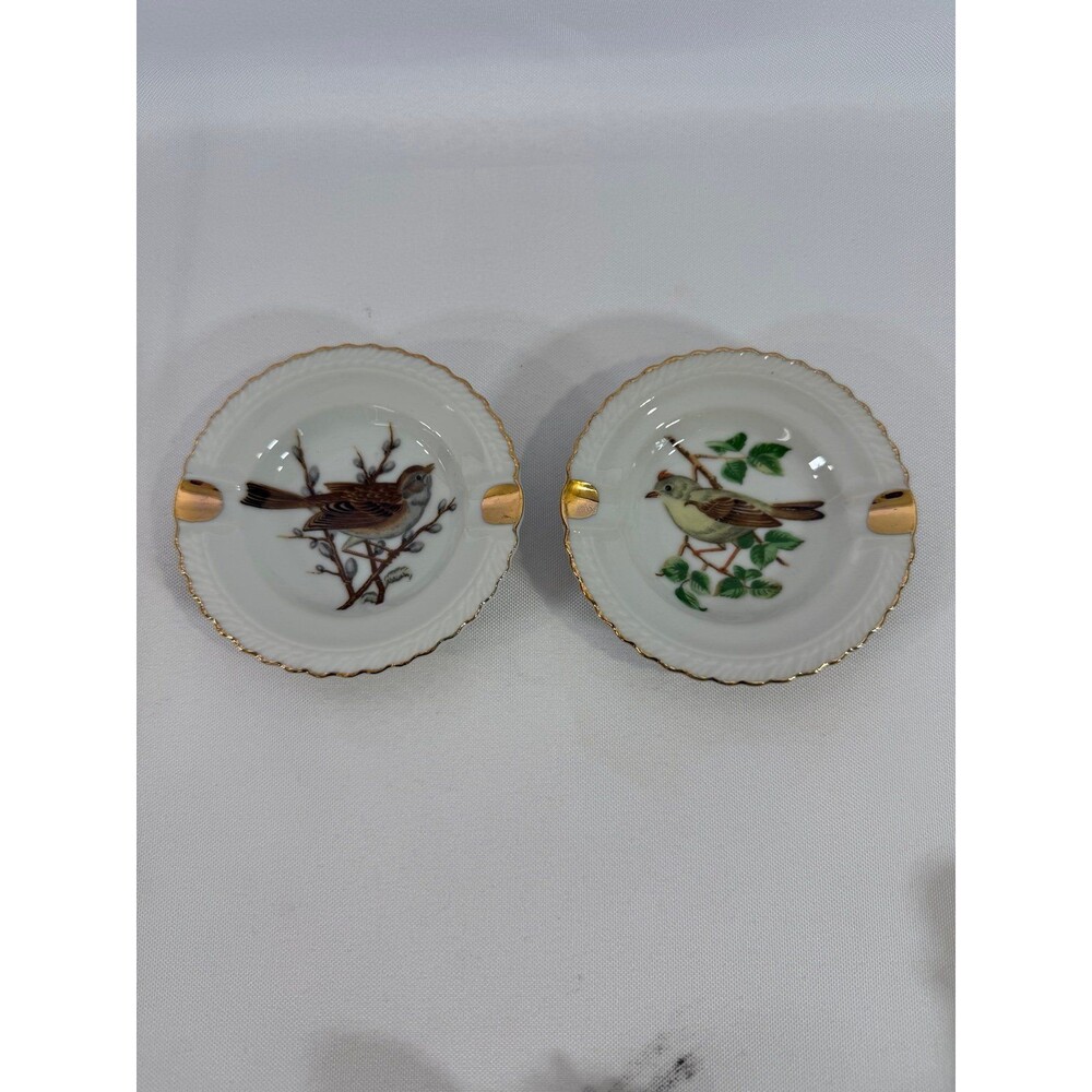 Set of 2 vintage porcelain ashtrays featuring bird motifs and gold trim 3.5”